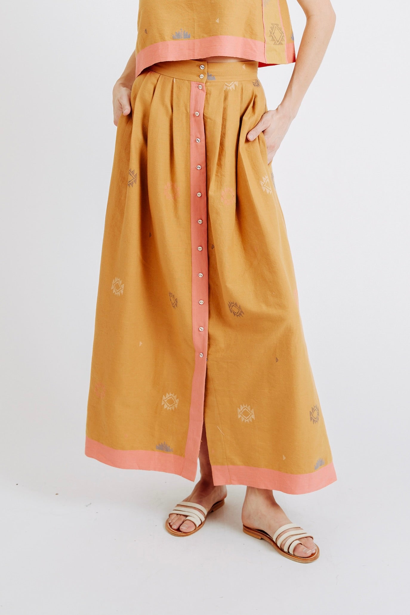 Girl wearing MIRTH women's long lucerne skirt set in handloomed sedona orange jamdani