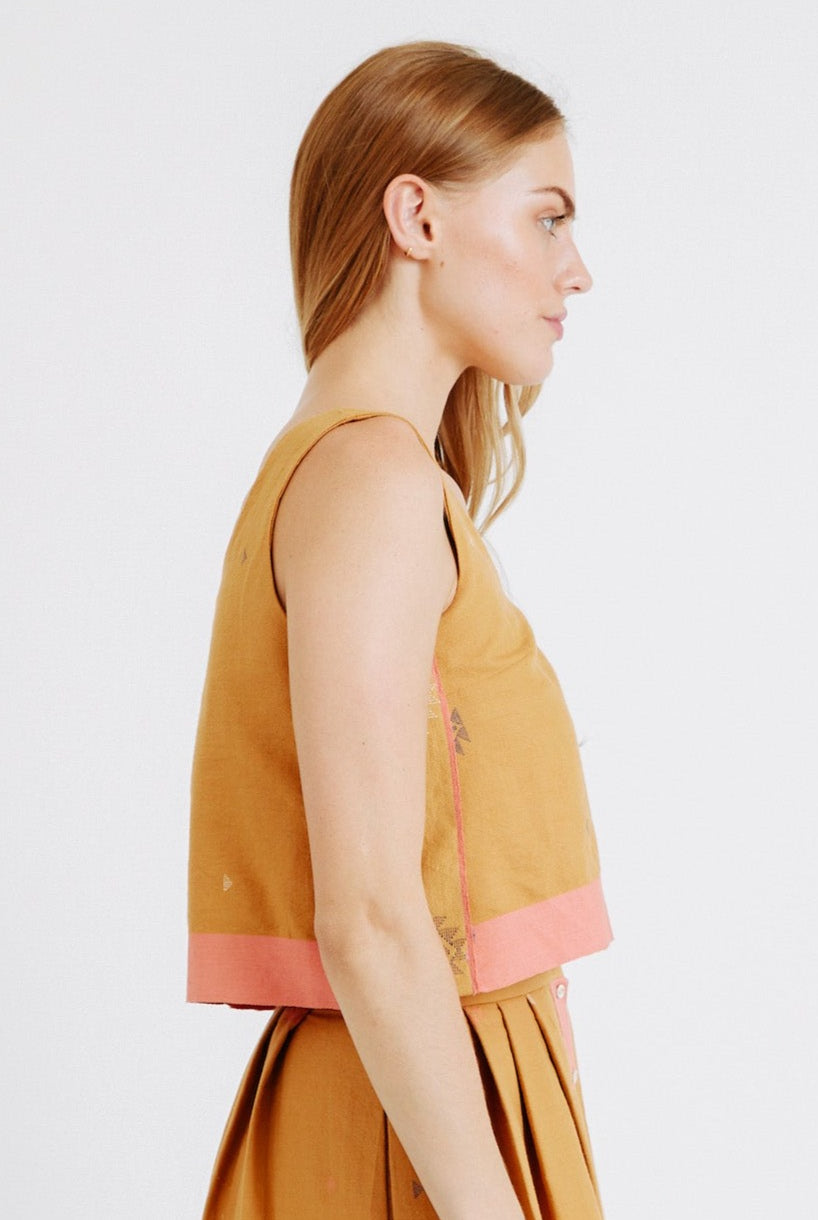 Girl wearing MIRTH women's sleeveless hudson tank top set in handloomed sedona orange jamdani cotton