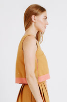 Girl wearing MIRTH women's sleeveless hudson tank top set in handloomed sedona orange jamdani cotton
