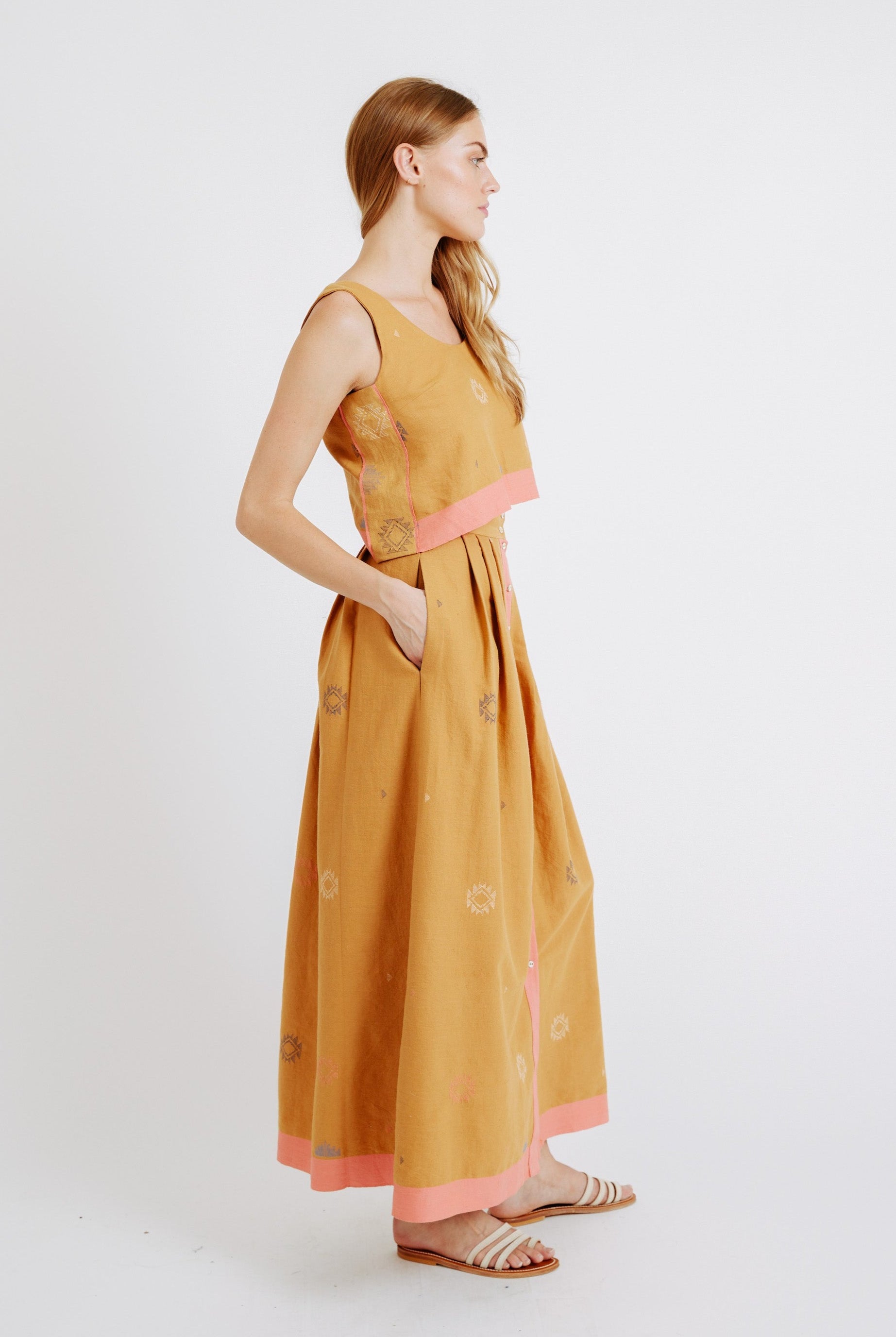 Girl wearing MIRTH women's long lucerne skirt set in handloomed sedona orange jamdani