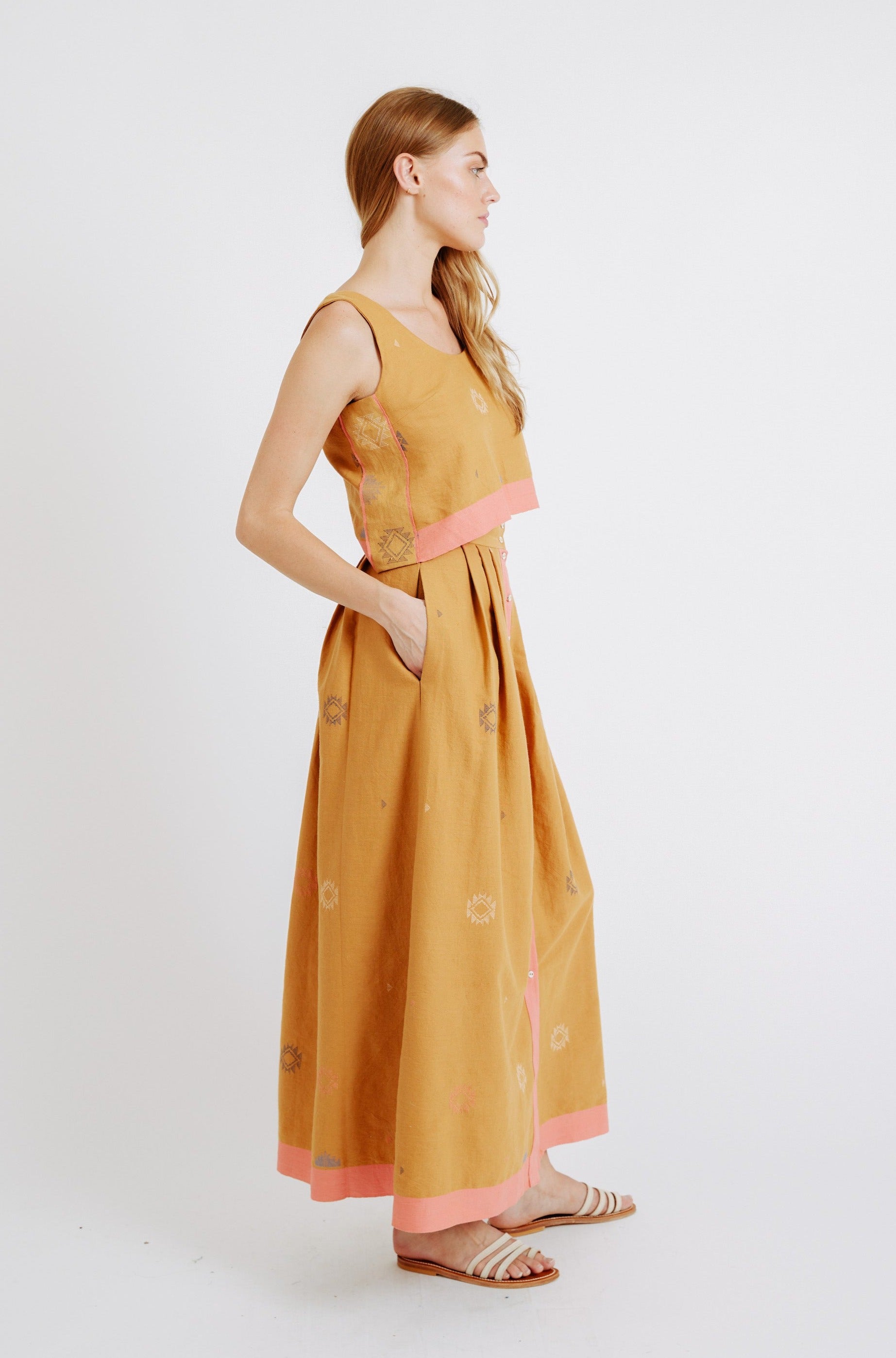 Girl wearing MIRTH women's long lucerne skirt set in handloomed sedona orange jamdani