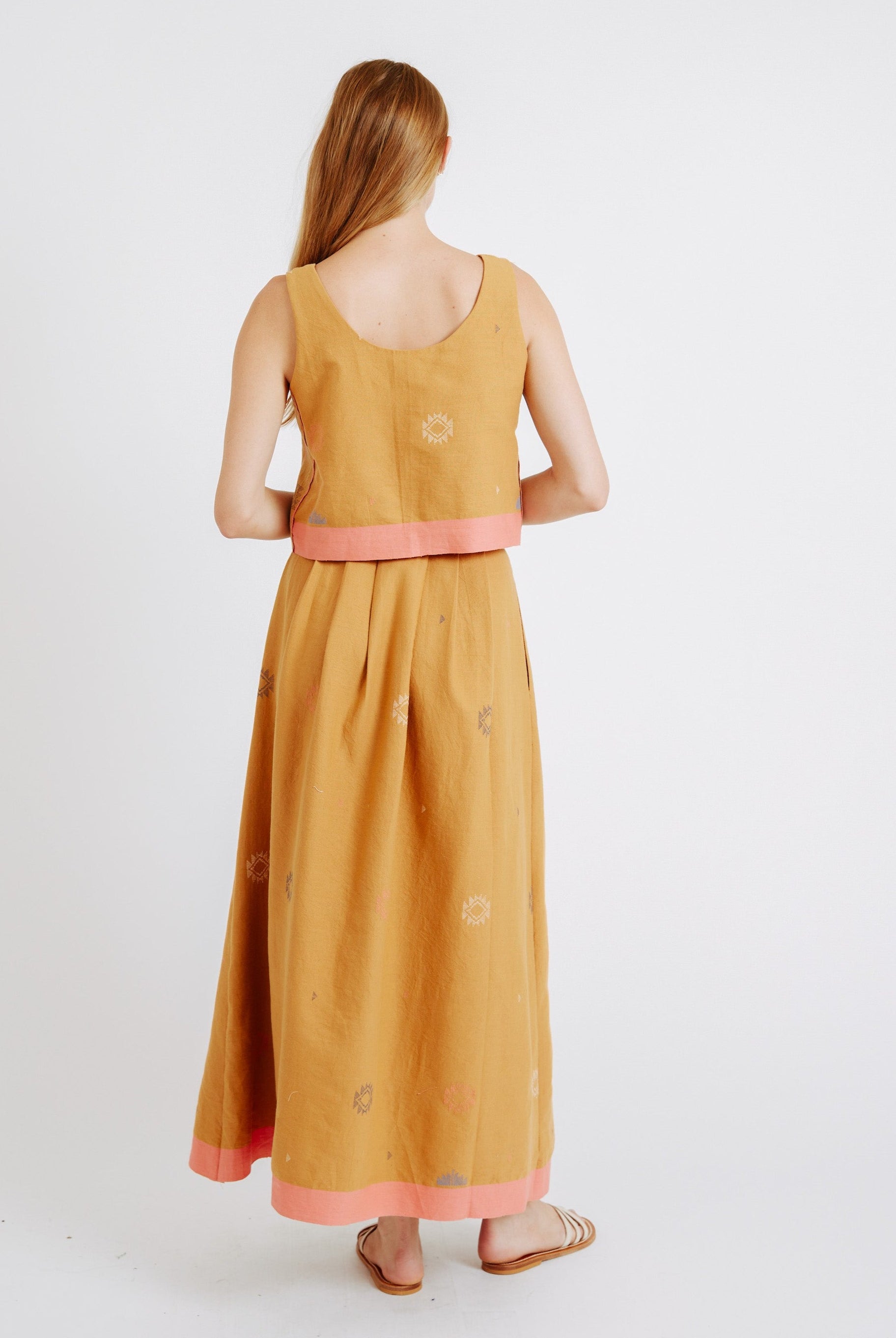 Girl wearing MIRTH women's sleeveless hudson tank top set in handloomed sedona orange jamdani cotton