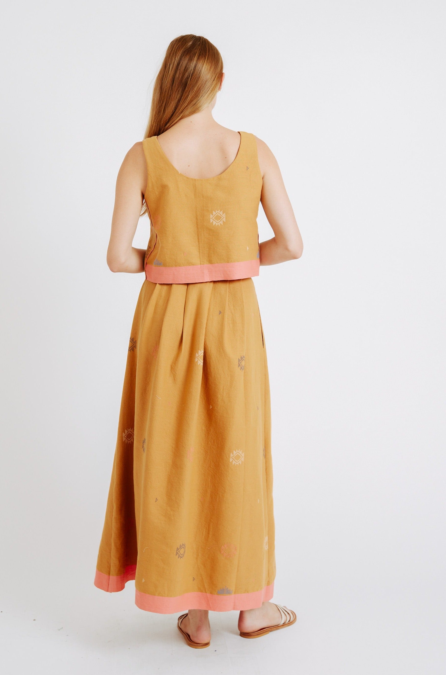 Girl wearing MIRTH women's sleeveless hudson tank top set in handloomed sedona orange jamdani cotton