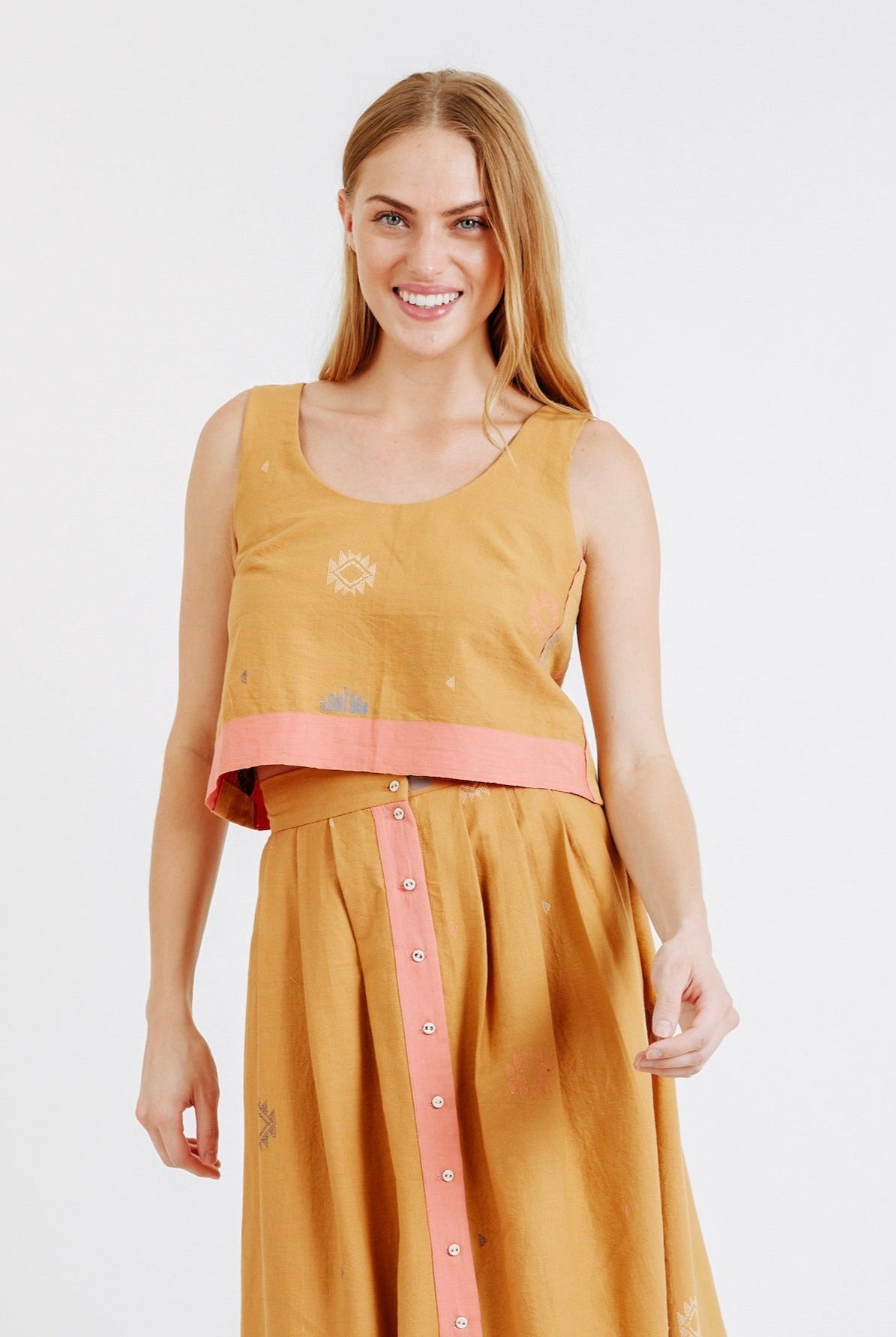 Girl wearing MIRTH women's sleeveless hudson tank top set in handloomed sedona orange jamdani cotton