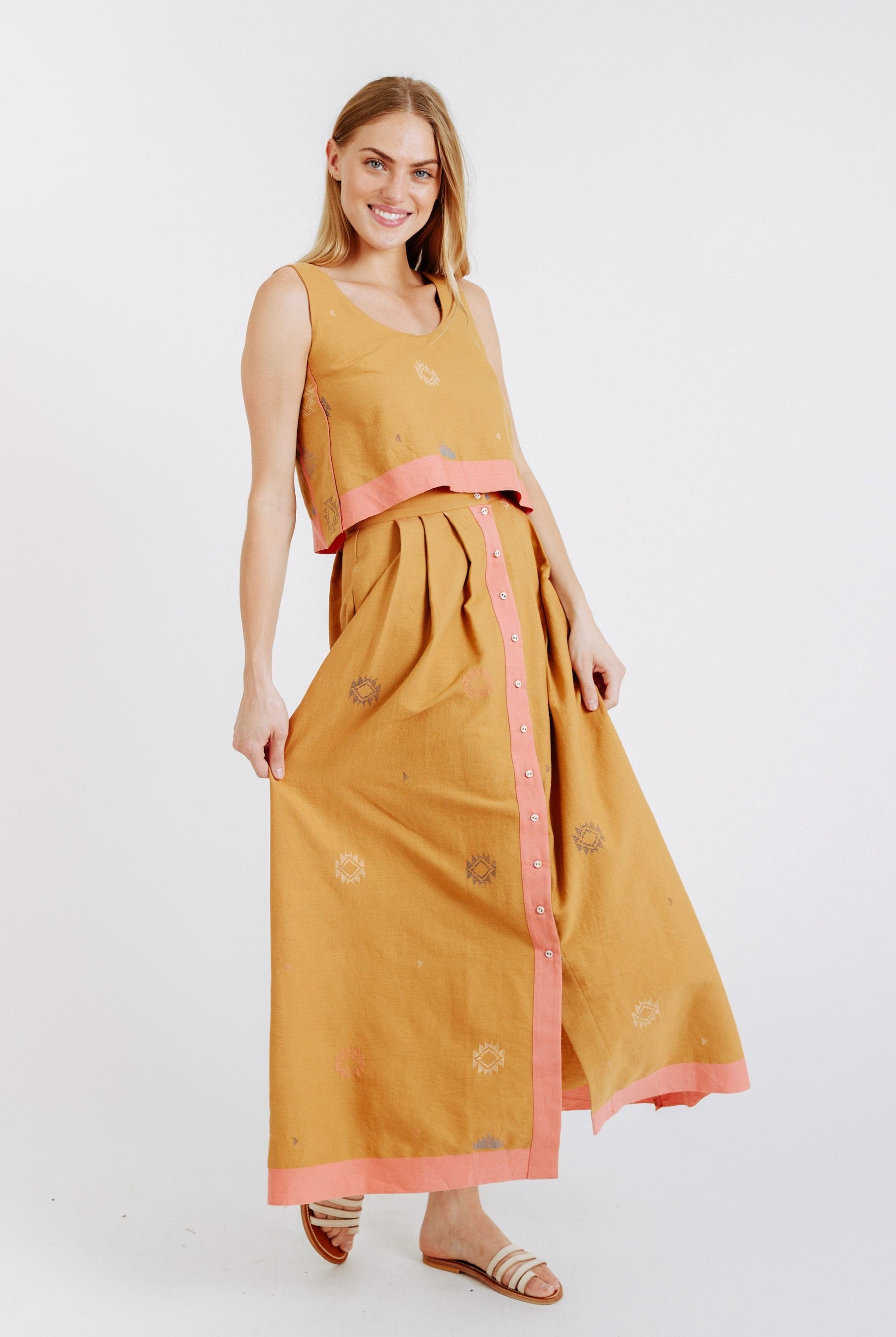 Girl wearing MIRTH women's long lucerne skirt set in handloomed sedona orange jamdani