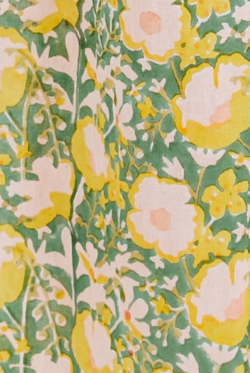 Girl wearing MIRTH women's long singapore spaghetti strap drop waist dress in camelia bloom green floral print cotton