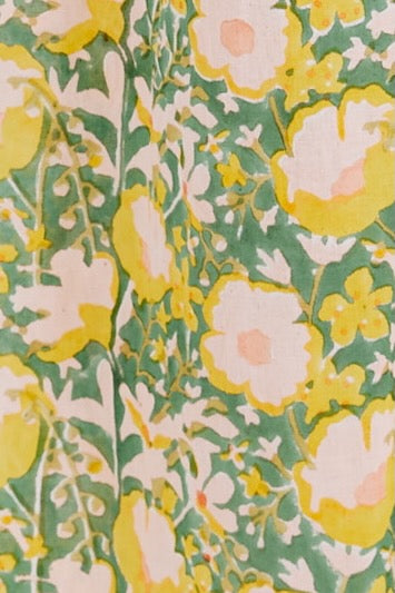 Girl wearing MIRTH women's long singapore spaghetti strap drop waist dress in camelia bloom green floral print cotton