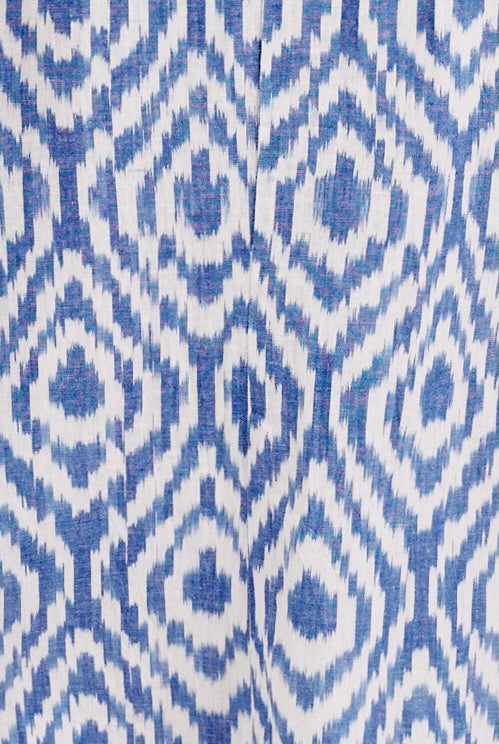 Girl wearing MIRTH women's wide leg elastic waist track shorts in azure ikat blue cotton