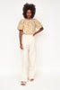 Girl wearing MIRTH women's ballon sleeve andaman cropped top in brown driftwood cotton silk
