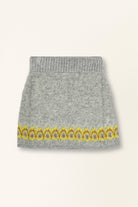 Gray knit skirt with yellow floral embroidery on a white background