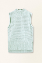 Light blue sleeveless knitted vest on a beige background
