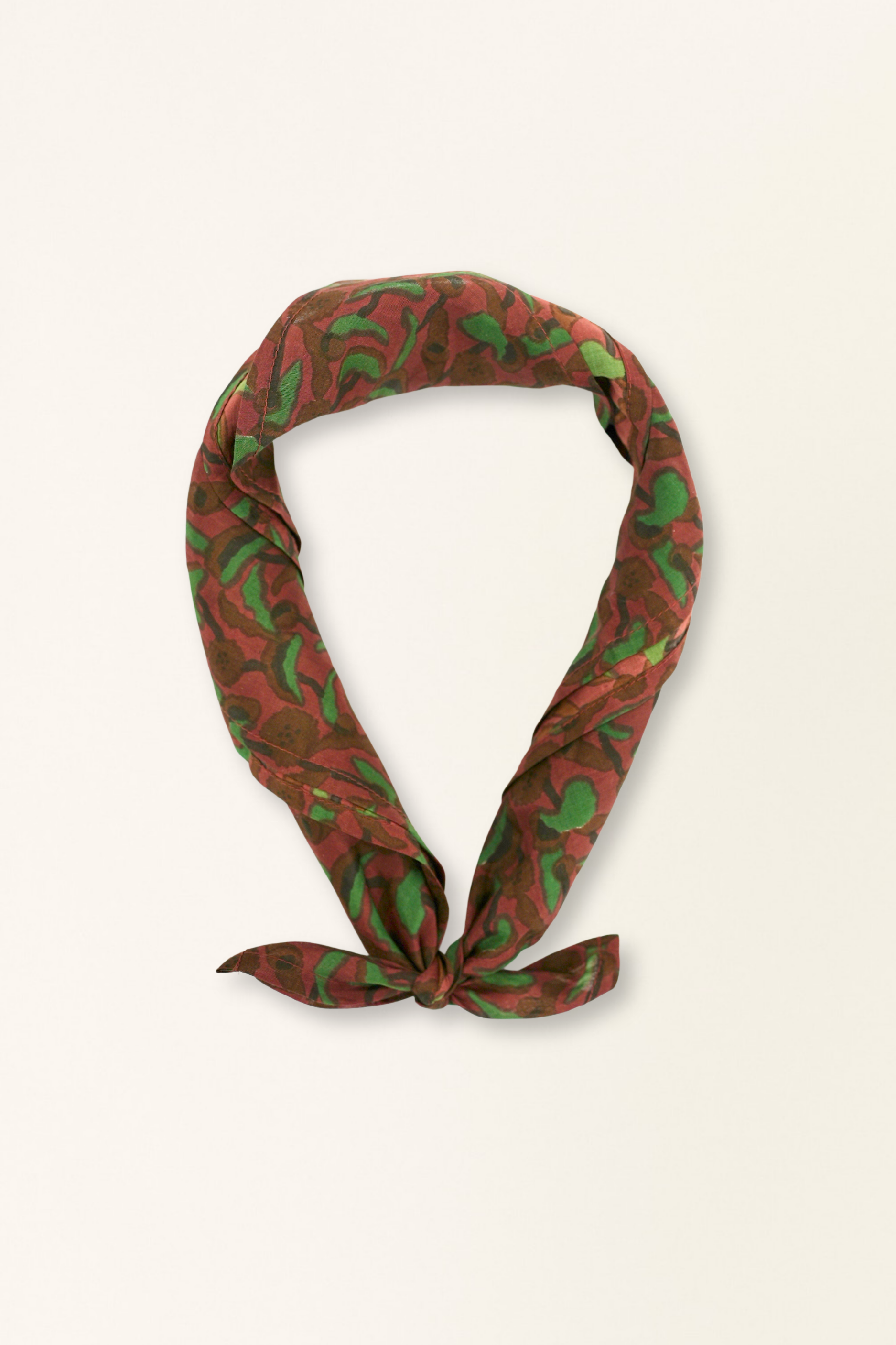 Red and green patterned headscarf on a white background