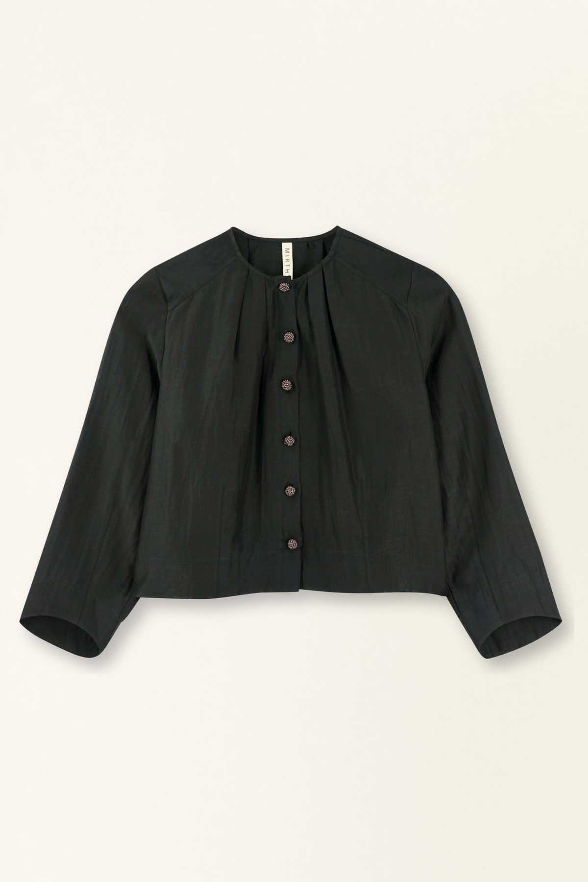 Black jacket with button details on a beige background