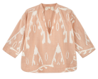 Girl wearing MIRTH women's v neck three quarter sleeve camden top in peach conch ikat handloomed cotton