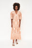 Girl wearing MIRTH women's puff sleeve v neck cassis long dress in conch ikat peach cotton