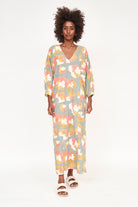 Girl wearing MIRTH women's v neck open back belted curacao long caftan in waterlily print cotton