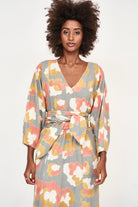 Girl wearing MIRTH women's v neck open back belted curacao long caftan in waterlily print cotton