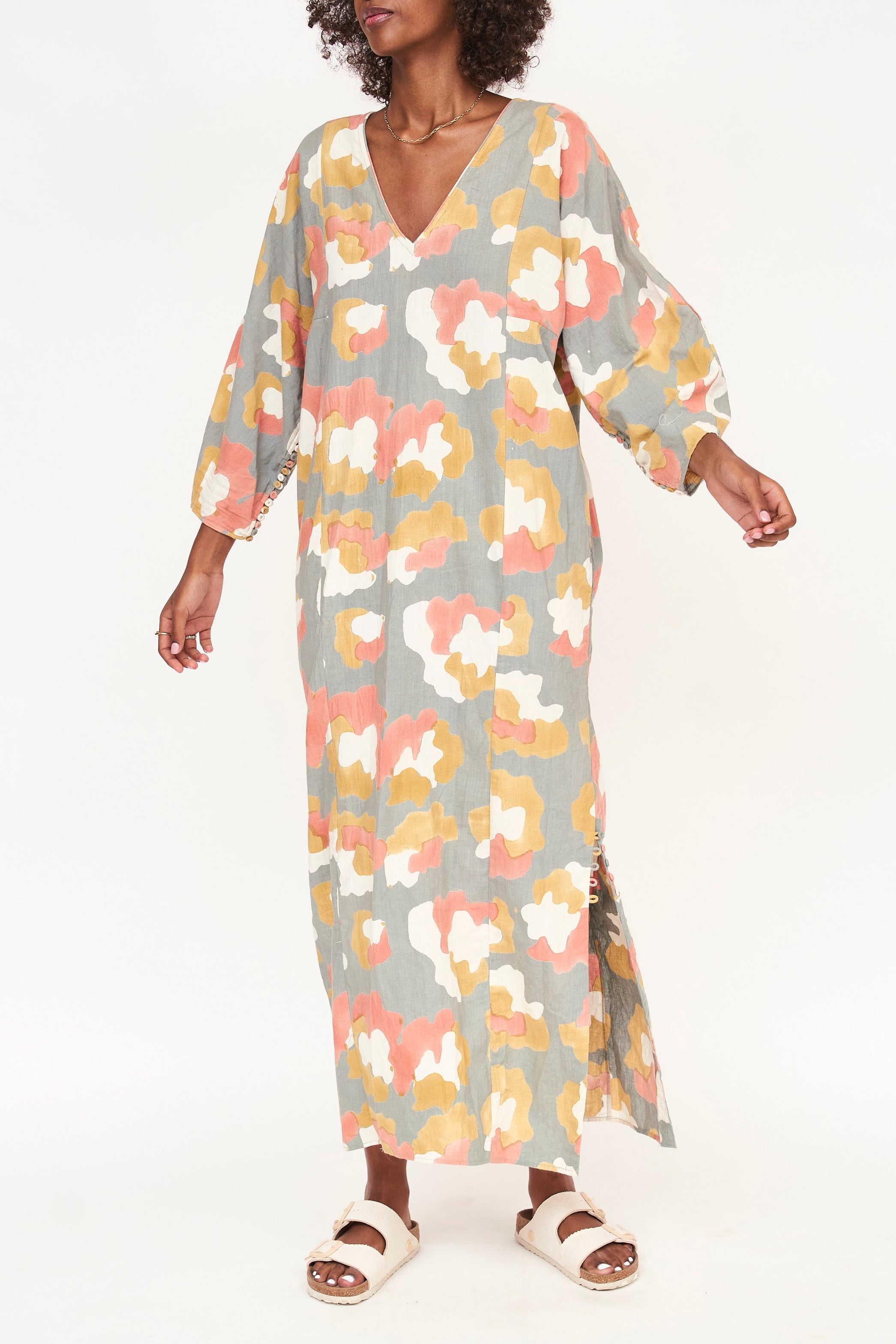 Girl wearing MIRTH women's v neck open back belted curacao long caftan in waterlily print cotton