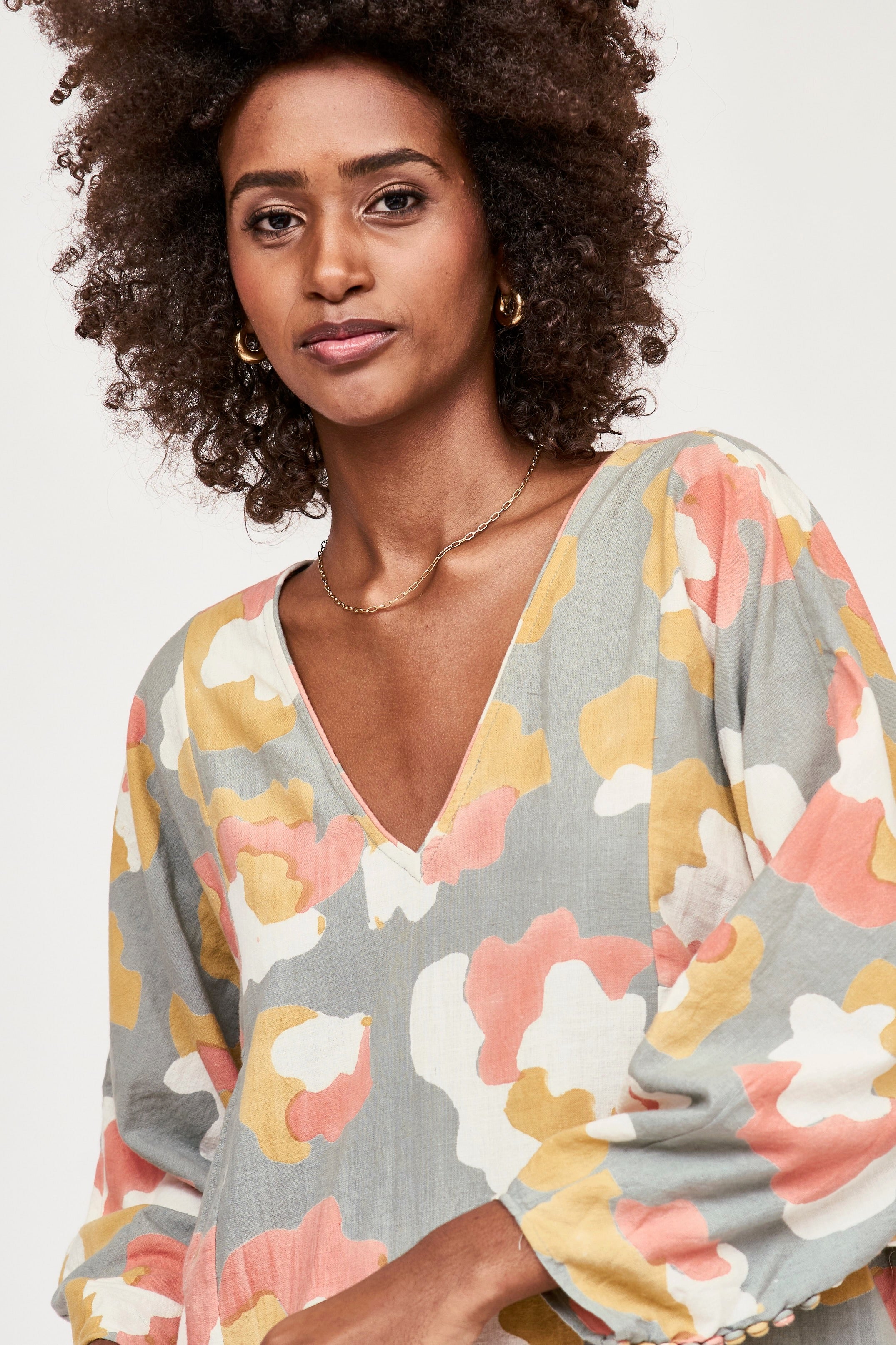 Girl wearing MIRTH women's v neck open back belted curacao long caftan in waterlily print cotton