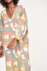 Girl wearing MIRTH women's v neck open back belted curacao long caftan in waterlily print cotton