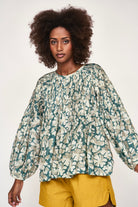 Girl wearing MIRTH women's long sleeve kerala blouse in plumeria blue print floral cotton