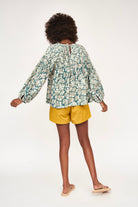 Girl wearing MIRTH women's long sleeve kerala blouse in plumeria blue print floral cotton