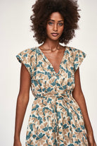 Girl wearing MIRTH women's v neck short sleeve komodo short dress in plumeria blue floral print cotton