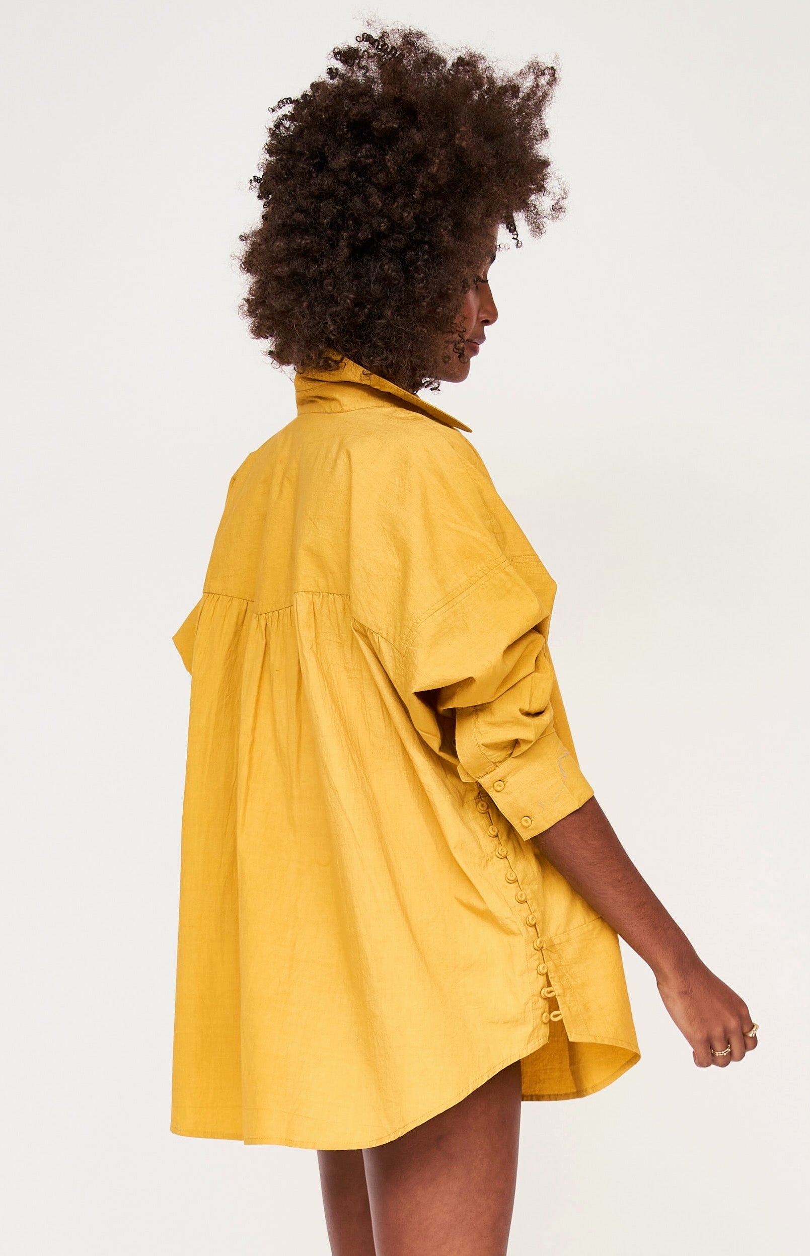 Girl wearing MIRTH women's button up long sleeve kyoto shirt in gilded yellow cotton