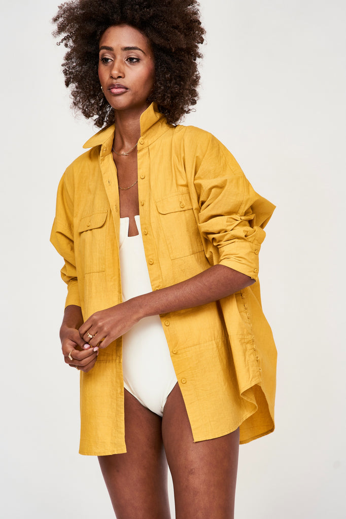 Girl wearing MIRTH women's button up long sleeve kyoto shirt in gilded yellow cotton