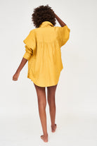 Girl wearing MIRTH women's button up long sleeve kyoto shirt in gilded yellow cotton