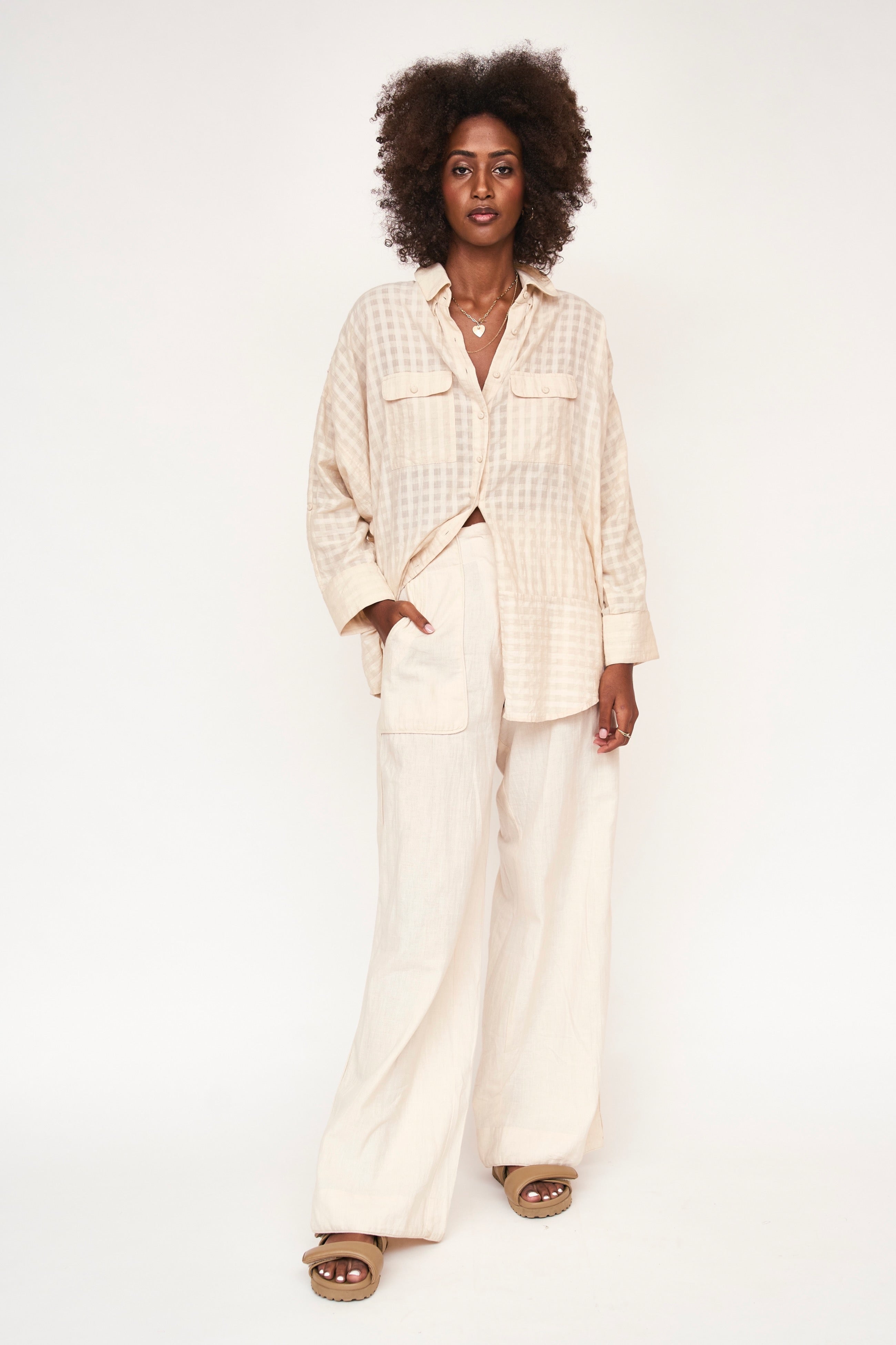 Girl wearing MIRTH women's button up long sleeve kyoto shirt in parchment boxweave cream cotton