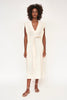 Girl wearing MIRTH women's v neck layered pintuck sleeveless long belted laguna dress in parchment cream cotton