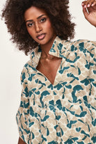 Girl wearing MIRTH women's v neck collared three quarter sleeve lanai top in plumeria blue floral print cotton