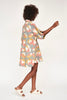 Girl wearing MIRTH women's v neck collared three quarter sleeve lanai short dress in waterlily print cotton