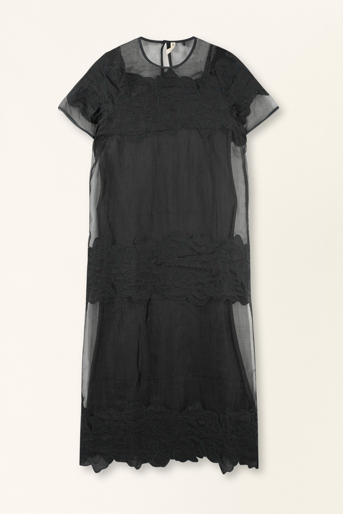 Black sheer dress with lace details on a white background