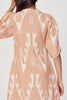 Girl wearing MIRTH women's puff sleeve v neck cassis short dress in conch ikat peach cotton