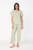 Girl wearing MIRTH women's short sleeve pajama pant set in jawbreaker green cotton