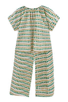 Girl wearing MIRTH women's short sleeve pajama pant set in jawbreaker green cotton