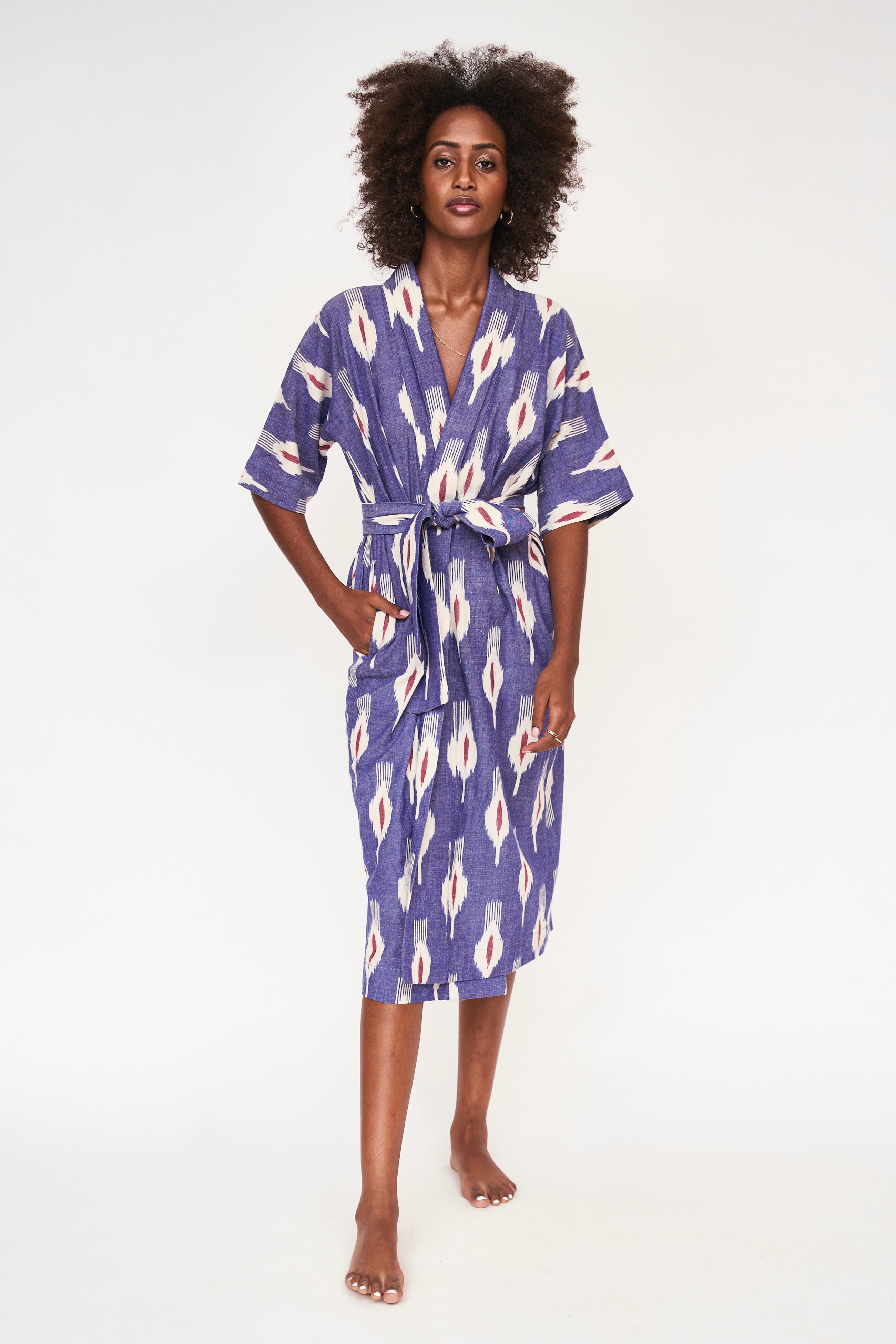 Girl wearing MIRTH women's laos cotton bathrobe in nautical ikat blue cotton