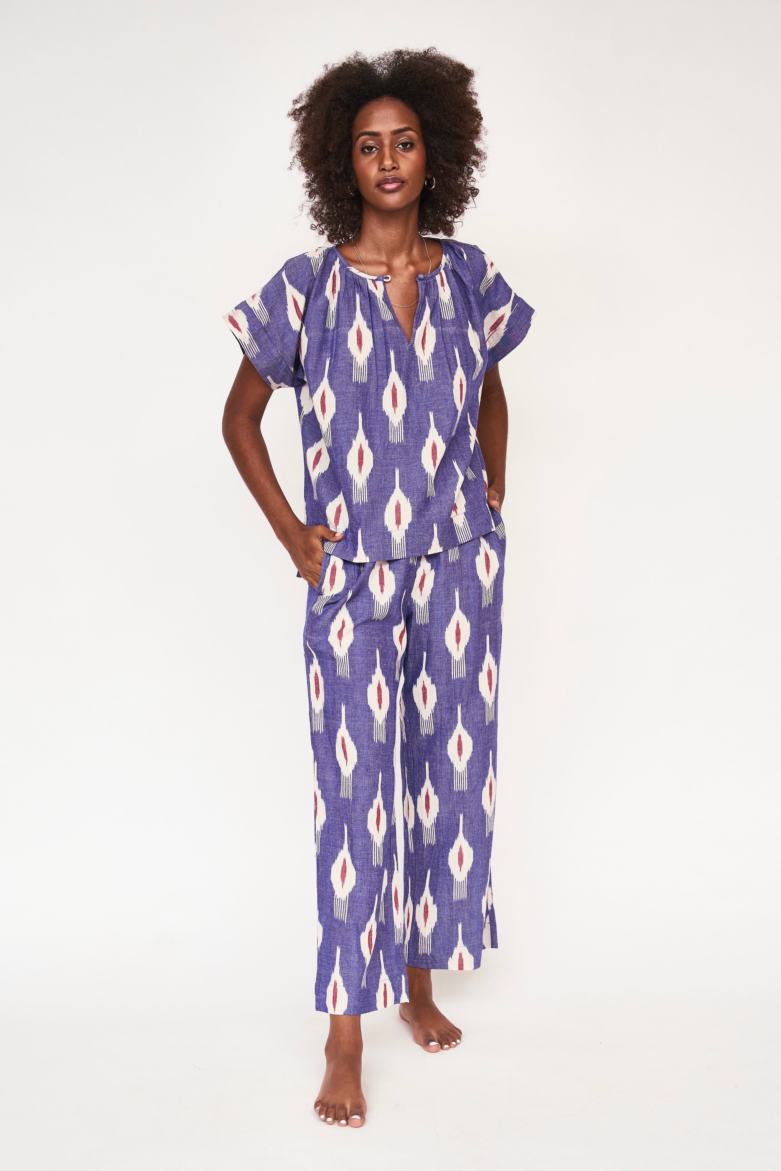 Girl wearing MIRTH women's short sleeve pajama pant set in nautical ikat blue cotton