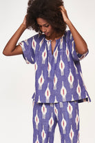 Girl wearing MIRTH women's short sleeve pajama pant set in nautical ikat blue cotton