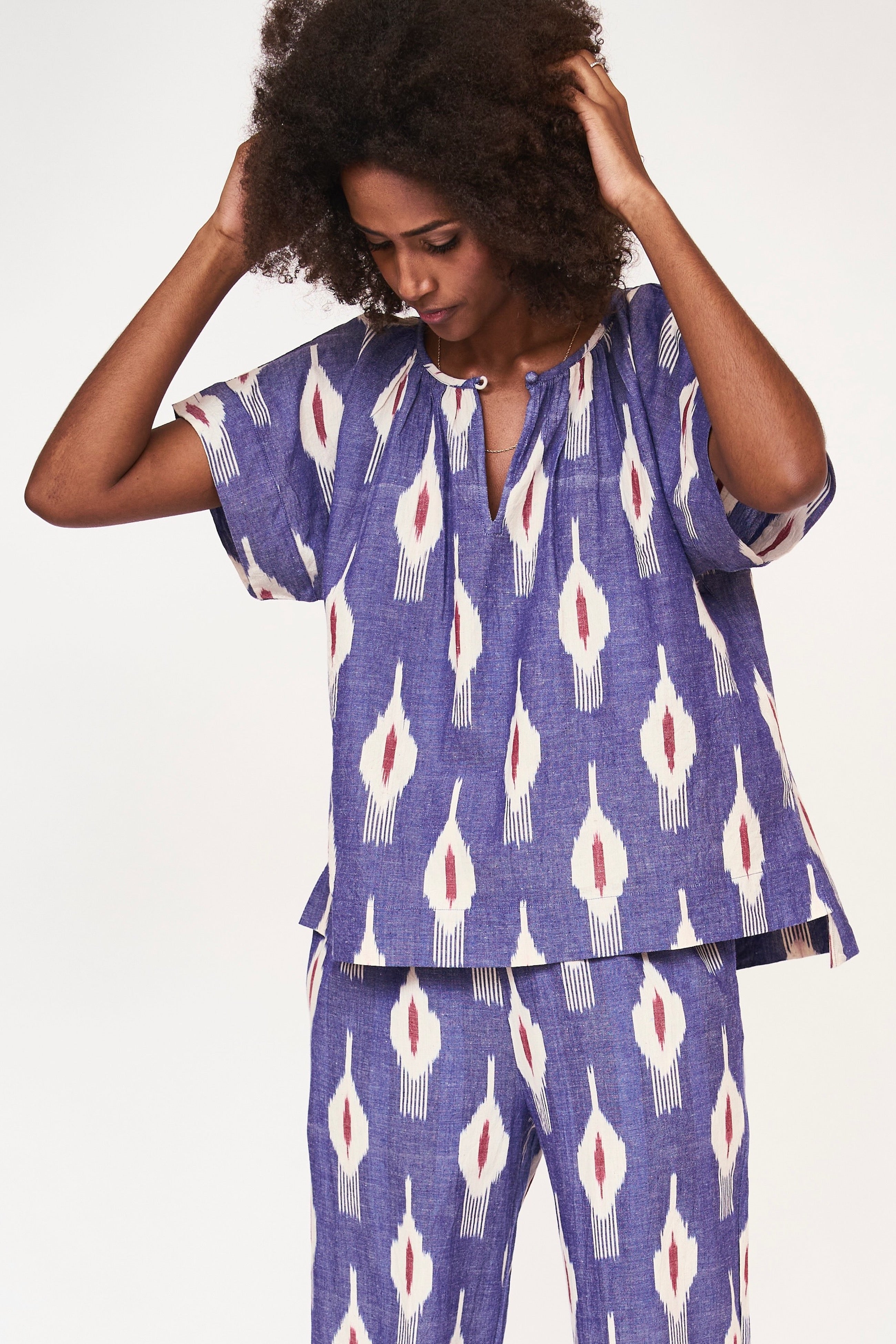 Girl wearing MIRTH women's short sleeve pajama pant set in nautical ikat blue cotton