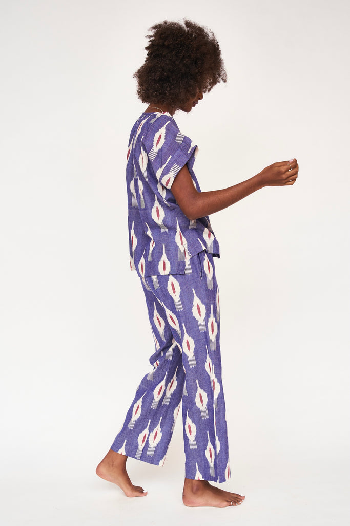 Girl wearing MIRTH women's short sleeve pajama pant set in nautical ikat blue cotton