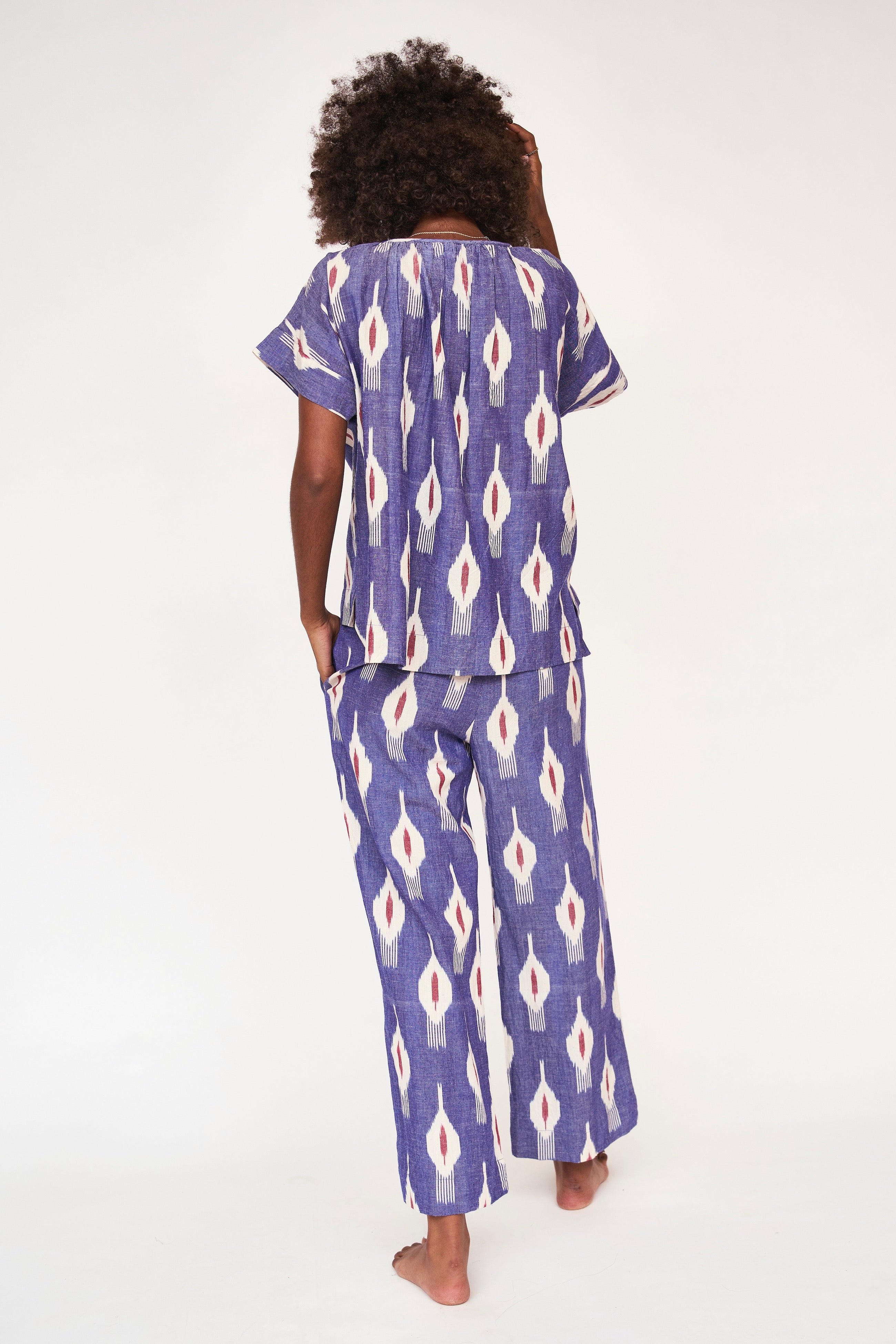 Girl wearing MIRTH women's short sleeve pajama pant set in nautical ikat blue cotton