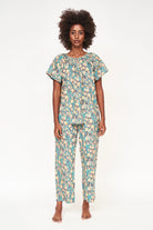 Girl wearing MIRTH women's short sleeve pajama pant set in onyx bloom floral cotton