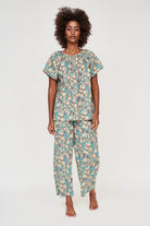 Girl wearing MIRTH women's short sleeve pajama pant set in onyx bloom floral cotton