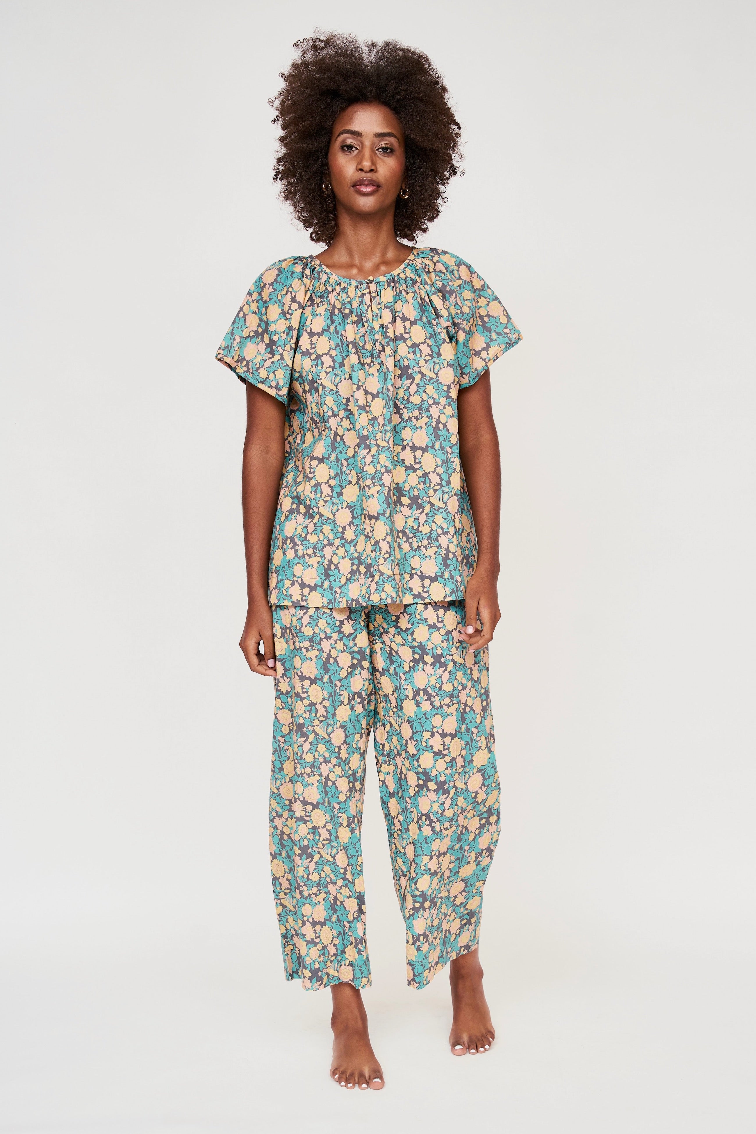 Girl wearing MIRTH women's short sleeve pajama pant set in onyx bloom floral cotton