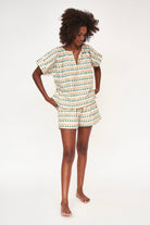 Girl wearing MIRTH women's short sleeve pajama short set in jawbreaker green cotton