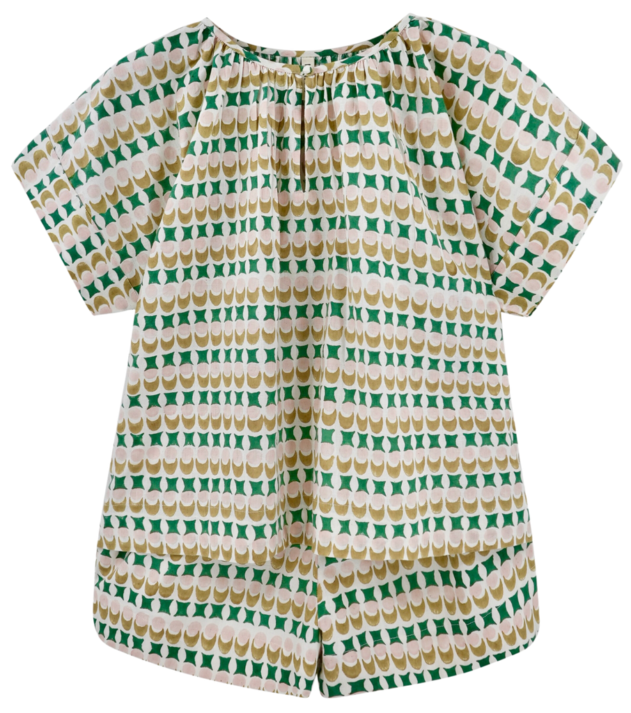 Girl wearing MIRTH women's short sleeve pajama short set in jawbreaker green cotton