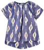 Girl wearing MIRTH women's short sleeve pajama short set in nauticak ikat blue cotton